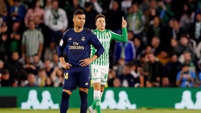 Real Madrid midfielder Casemiro reacts as Cristian Tello celebrates scoring Real Betis' second goal. Reuters