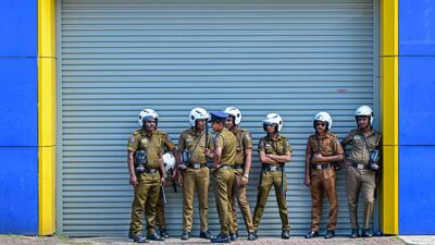 Police stand guard outside Sri Lanka's National Cricket Board office in Colombo, after Sports Minister Roshan Ranasinghe sacked all its members after a humiliating defeat by India at the World Cup. AFP