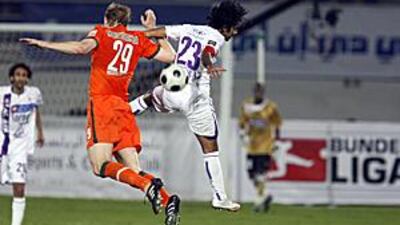 Al Ain's Shihab Ahmed, No 23, and Werder Bremen's Per Mertesacker go up for a header.