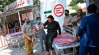A wounded Afghan man prepares to stand from a stretcher after he received treatment at an Italian aid organisation hospital, following the rocket attack in Kabul. AFP