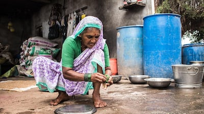 The mhaka leaves are squeezed several times to extract the greenish-black liquid.