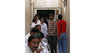 People queue up to secure their Machine Readable Passports at the Pakistani consulate in Dubai. Jeffrey E Biteng / The National