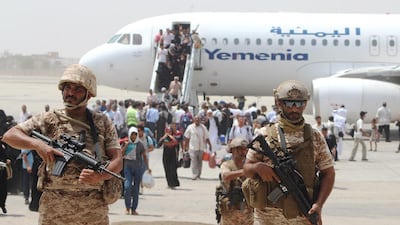 Security stands guard as passengers disembark in August 2015. Yemenia is seeking to resume flights to the Arabian Gulf and Africa. AFP