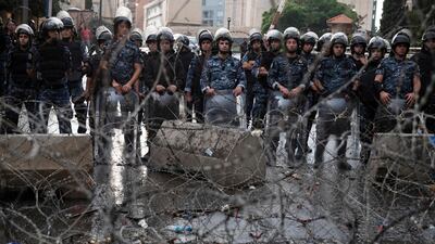 Riot police stand guard behind barbed-wire next to the Government Palace in downtown Beirut. Reuters