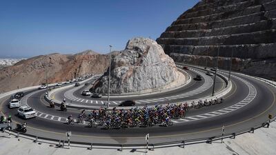 The peloton rides during the third stage of the 2022 cycling Tour of Oman between Sultan Qaboos University and Qurayyat. AFP