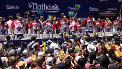The crowd cheers the competitive eaters on. AFP