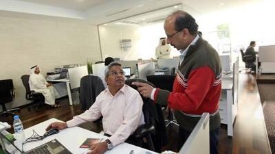 Dubai Internet City head of campus management Hamza Bawa (seated), speaks to Idama team leader D.L. Narasimhan at their offices.