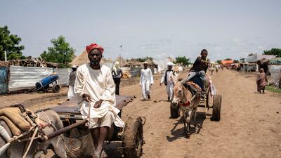 An Eritrean man rides his donkey-drawn cart to the market at the camp. Getty