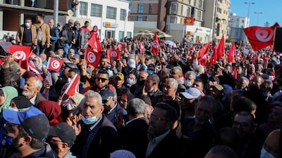 The streets of Tunis are filled with people and flags. AP