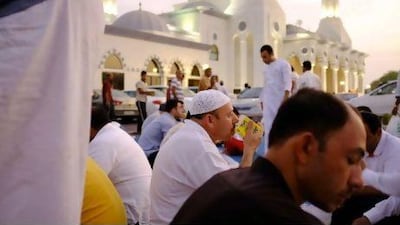 Reaching out: worshippers enjoy the Iftar meal outside the Al Farooq Umar ibn Khattab Mosque in Umm Suqeim.