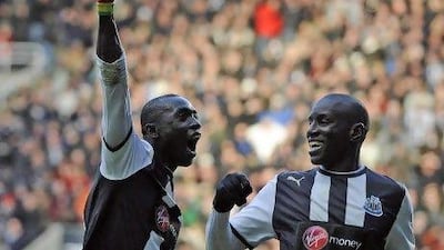 Newcastle United's Papiss Cisse, left, celebrates scoring with Demba Ba against Aston Villa during their English Premier League in Newcastle.