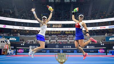 Yung-Jan Chan and Martina Hingis jump around the winner's trophy after winning the Women's Doubles Final against Timea Babos and Andrea Hlavackova at the 2017 China Open in Beijing. Photo by Etienne Oliveau / Getty Images