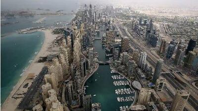 Construction has resumed on many of the skyscrapers that make up the Dubai Marina skyline, while others that are already completed now house many of the estimated 4,000 new residents that arrive in Dubai each month. Mike Young / The National