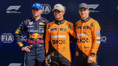 McLaren's Lando Norris, centre, celebrates his pole position with second-placed Red Bull driver Max Verstappen, left, and third-placed Oscar Piastri of McLaren. AP
