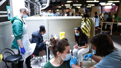 A person receives a dose of the Pfizer/BioNTech vaccine at a mass vaccination centre at the London Stadium. Reuters