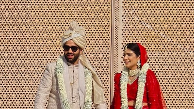 The couple are all smiles as they acknowledge their 750 guests after the varmala ceremony