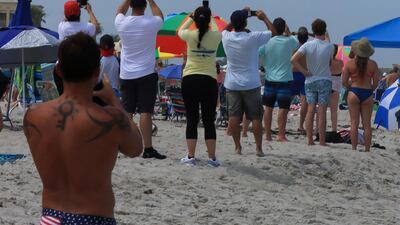 People view the launch from a beach in Florida. Reuters