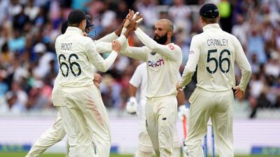 Moeen Ali celebrates with his team mates after dismissing Ajinkya Rahane at Lord's.