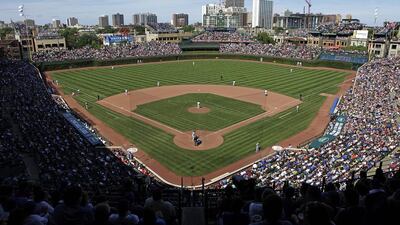 In this August 4, 2013, file photo, the Los Angeles Dodgers play the Chicago Cubs at Wrigley Field in Chicago. Wrigley Field has been the site of so much heartbreak that some fans who spend their whole lives waiting for a winner ask their families, if they can pull it off, to sneak their ashes inside to be scattered in the friendly confines - a final resting place to keep on waiting. But before years turned into decades and decades turned into a century without a World Series title, Wrigley Field was in first time and time again in changing the way we watch baseball and the experience for fans in ballparks around the country. Kiichiro Sato / AP