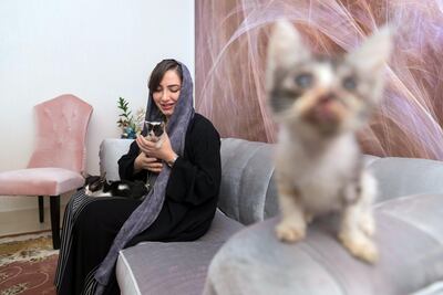 Dr Manal Al Mansoori at home with three rescued kittens. Antonie Robertson / The National