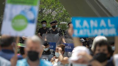 Turkish police officers watch a demonstration in Istanbul against President Recep Tayyip Erdogan's canal project. AP Photo