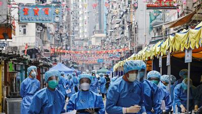 Health workers are seen in protective gear inside a locked down portion of the Jordan residential area in Hong Kong, China. Reuters