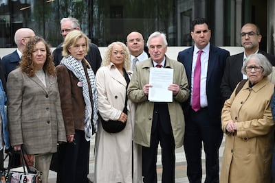 Labour Party veteran John McDonnell displays a letter to be delivered to Met Police commissioner Sir Mark Rowley, with actress Juliet Stevenson, second left, and other MPs and campaigners. Getty Images