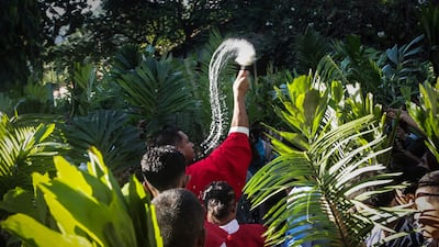 A Catholic priest sprinkles holy water during Palm Sunday Mass, commemorating Jesus Christ’s entry into Jerusalem, at Balide Church in Dili, East Timor. AFP