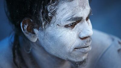 A Hindu holy man, or Sadhu, sits near the fire to keep himself warm on the first day of the Swasthani Brata Katha festival in Kathmandu. Navesh Chitrakar / Reuters