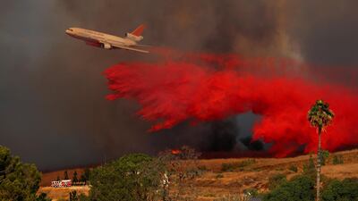 A DC-10 aircraft drops fire retardant in Orange, California. Mike Blake / Reuters