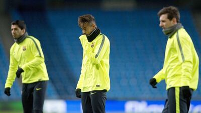 Barcelona's Neymar, centre, shown with Luis Suarez, left, and Lionel Messi, right, during their team's training session on Monday ahead of a Champions League match on Tuesday. Oli Scarff / AFP