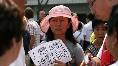 A Chinese woman pleads for tickets. Chinese pride in the Olympics is fuelling record profits for black market ticket touts.