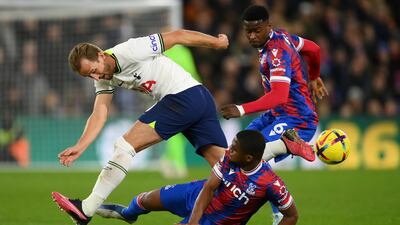 Spurs striker Harry Kane is tackled by Cheick Doucoure and Marc Guehi of Crystal Palace. Getty
