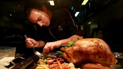 Chef Daniel Irvine prepares takeaway turkey meals at Jumeirah Etihad Towers hotel yesterday in Abu Dhabi. Preparations for the big day are a year-long job, says the hotel’s executive chef, Loughlin Druhan. Ravindranath K / The National