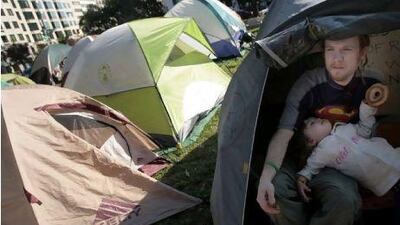 Soren Powell and his daughter, Willow, in the Occupy DC encampment in McPherson Square in Washington.
