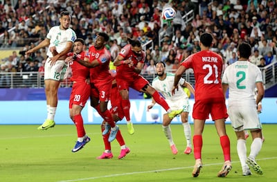 Nadhir Benbouali of Algeria, left, scores his team's equaliser. AFP