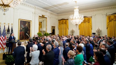 President Joe Biden receives a standing ovation as he speaks during the unveiling of the Obamas' official White House portraits. AP