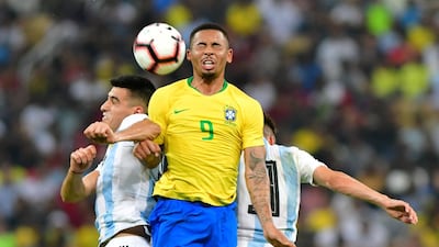 Brazil forward Gabriel Jesus tussles with Argentina's Rodrigo Battaglia and Nicolas Tagliafico. Reuters
