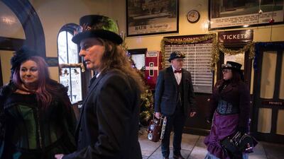 Steampunk enthusiasts wait for a steam train at Haworth station. AFP