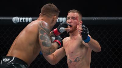 Dustin Poirier throws a punch against Justin Gaethje. AFP