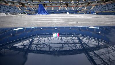 Rainwater puddles up the ledge of a port hole at Arthur Ashe Stadium, reflecting the not-yet completed retractable roof, after the women's semi-final matches were postponed because of rain on Thursday. Kathy Willens / AP