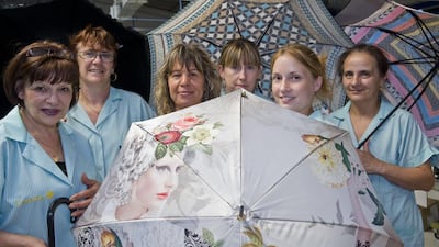 Workers show handcrafted umbrellas at Piganiol's manufacturing facility in Aurillac. Thierry Zoccolan / AFP
