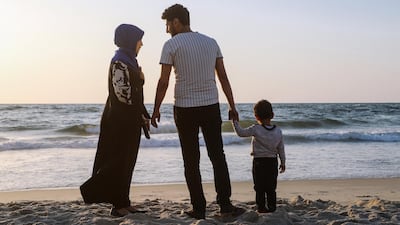 Hosan Horami, his wife and his son on the beach of Gaza City, June 5, 2018. Wilson Fache for The National
