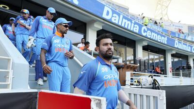 Rohit Sharma leads India out for the Super Four game. Chris Whiteoak / The National