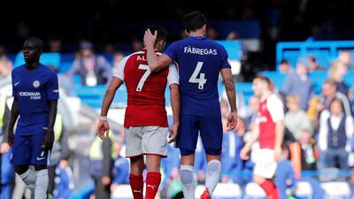 Cesc Fabregas, right, and Alexis Sanches after the game between Chelsea and Arsenal. Eddie Keogh / Reuters