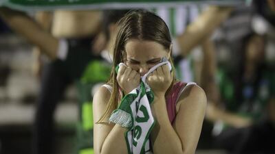 A fan of the Brazilian football team Chapecoense weeps during a gathering inside Arena Conda stadium in Chapeco, Brazil, on Tuesday, November 29, 2016 to mourn the footballers killed in an air crash near Medellin, Colombia. . Andre Penner / AP