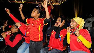 Spanish supporters Einas Asim al Khalifa, Sara al Amin, and Wageeda Salah cheer on their team at the Dubai Convention Centre.