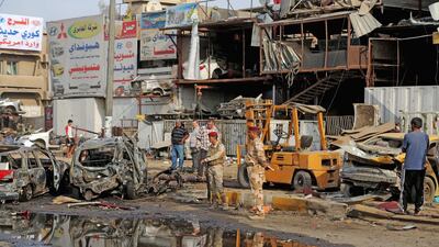 Security forces inspect the site of a car bomb explosion in the largely Shiite neighbourhood of Talibiyah in Baghdad. Khalid Mohammed / AP Photo / October 16, 2014
