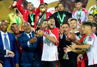 Wydad midfielder Yahya Jabrane celebrates with the trophy after beating Egypt's Al Ahly in the Caf Champions League final, on May 30, 2022. AFP