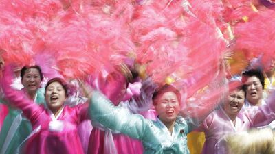 North Korean women wave and cheer as they look toward their leader Kim Jong-un. Wong Maye-E/AP Photo
